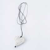 Small porcelain heart with star pattern and silver eye.
